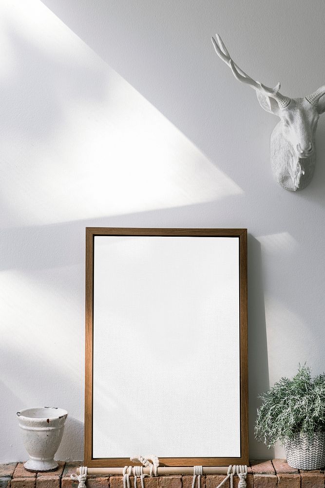 Wooden frame mockup against a white wall