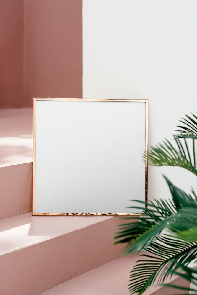 Golden shiny frame mockup on a pink stairway