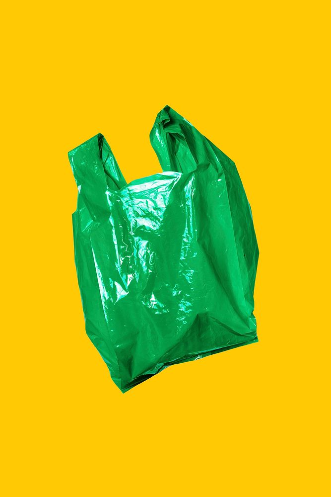 Green plastic bag on yellow wall