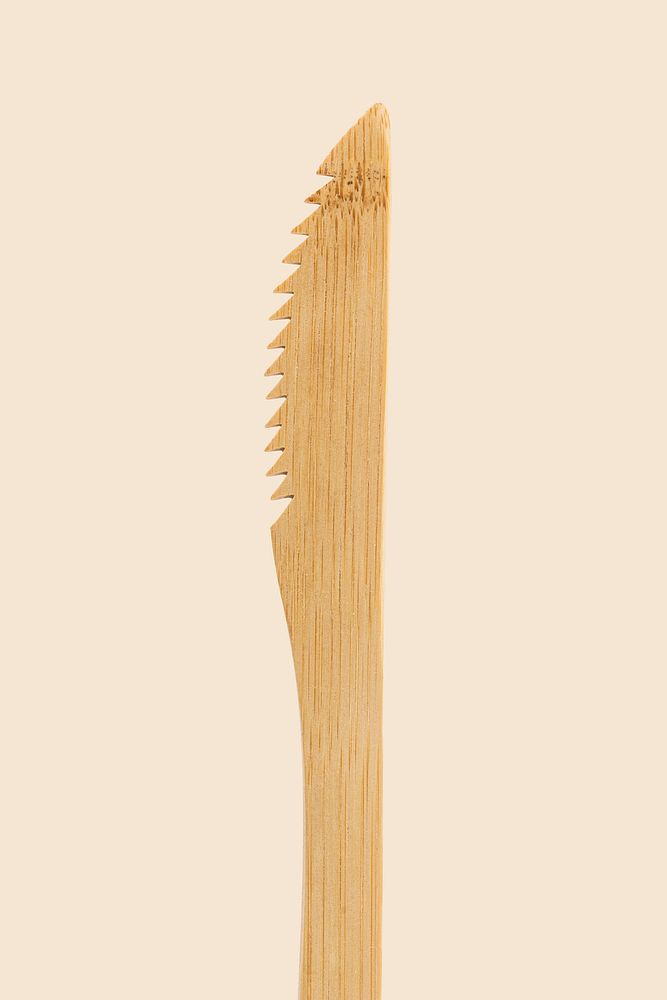 Wooden knife on cream background
