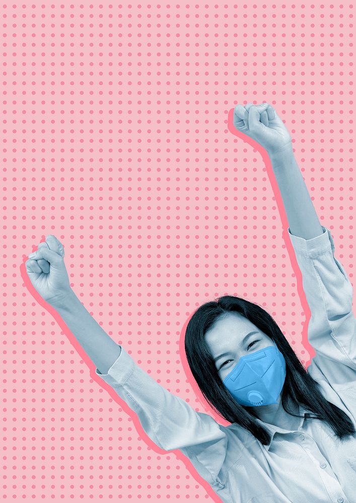 Cheerful Asian woman wearing a mask arms raised in a pink background