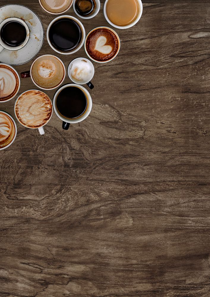Assorted coffee cups on a natural wooden textured background 