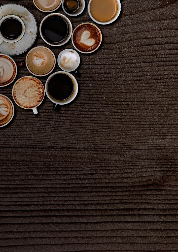 Coffee mugs on a dark brown wooden textured wallpaper