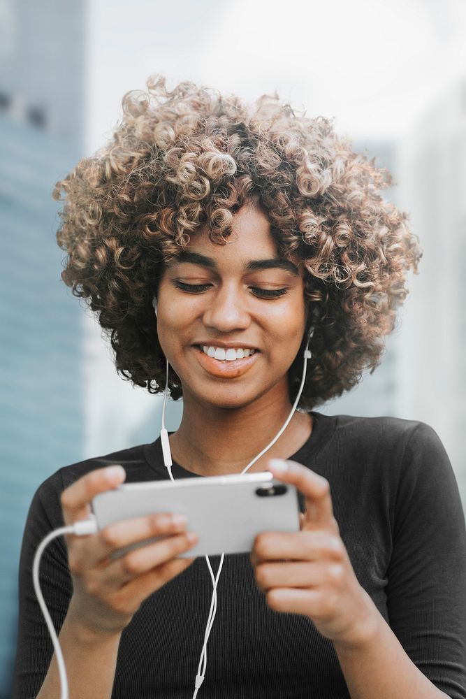 Beautiful woman using smartphone in the city remixed media