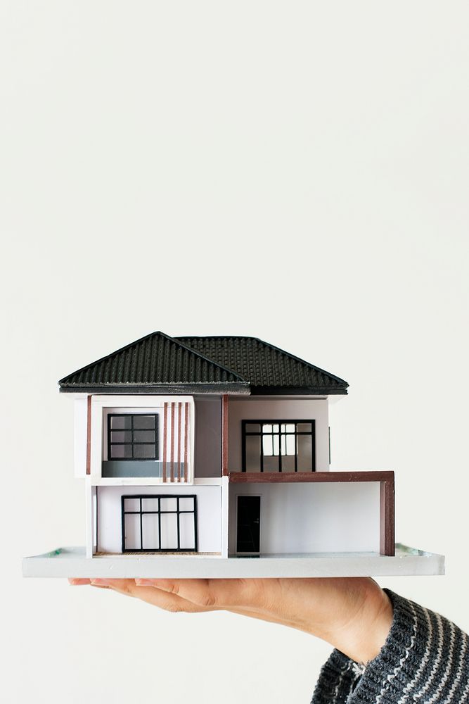 Home loan, hand holding house model