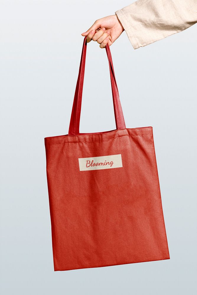 Woman holding red tote bag