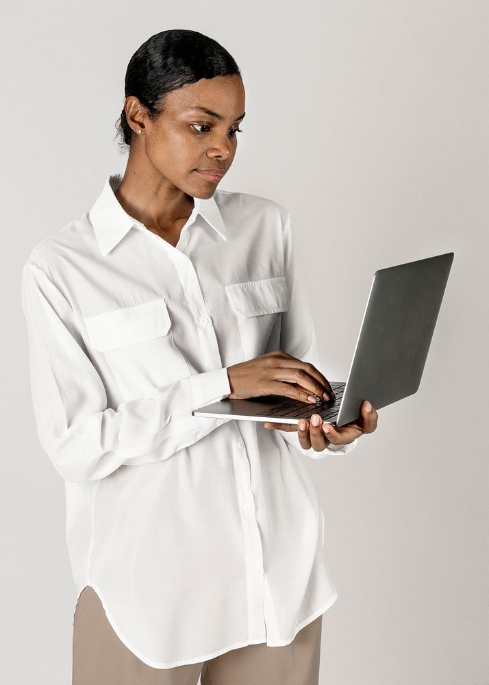 Black woman using a laptop on white background