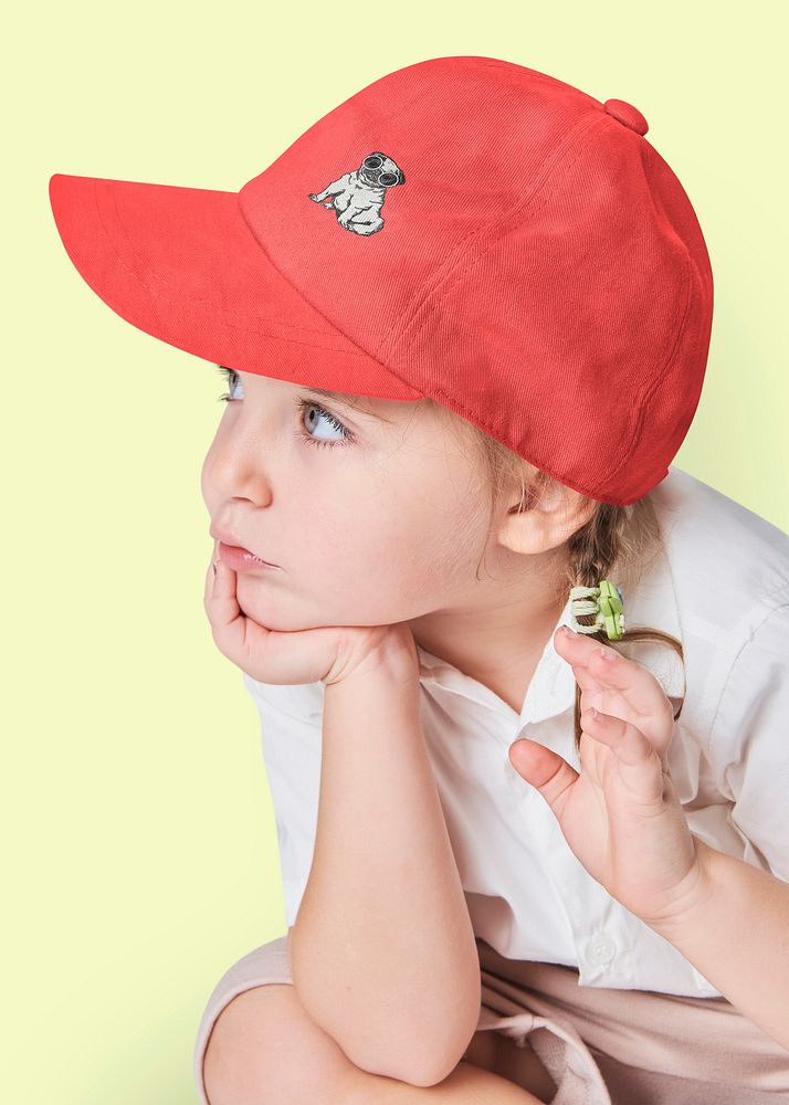 Little girl wearing red cap, kid's fashion photo