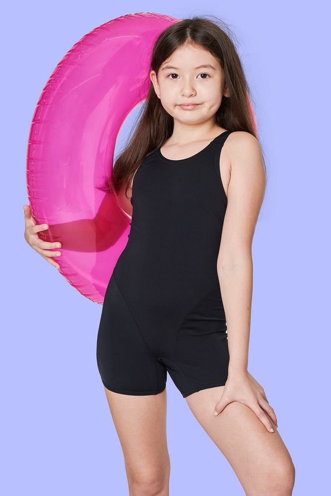 Girl wearing swimwear holding a inflatable tube