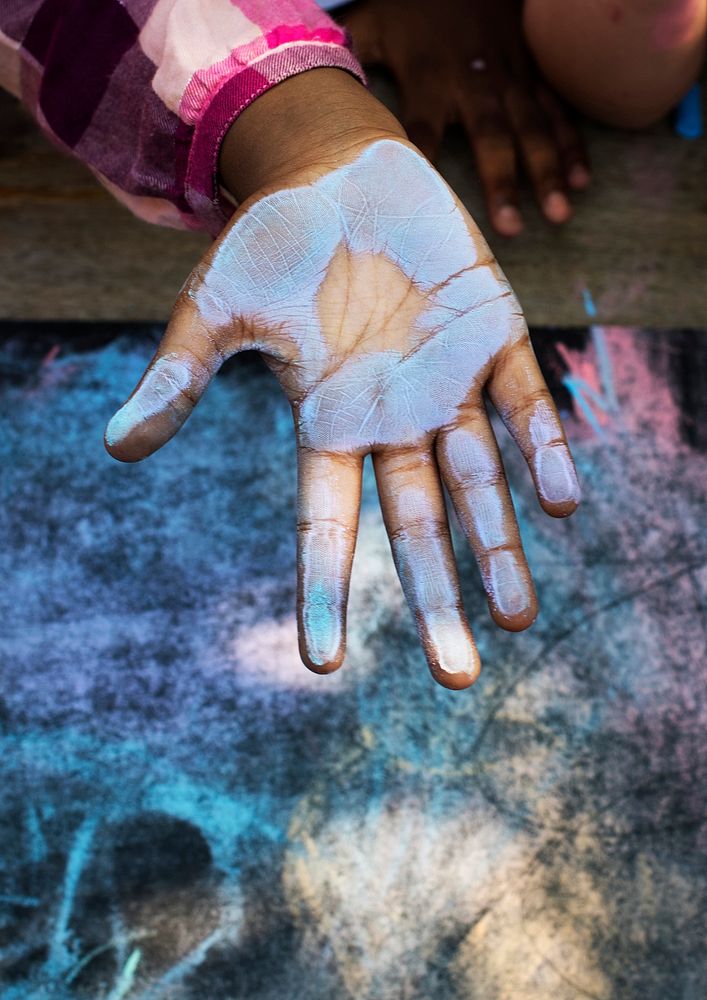 Blue chalk paint on kid hand
