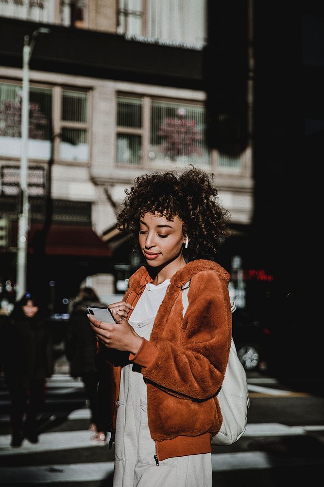 Woman listening to music, city photo