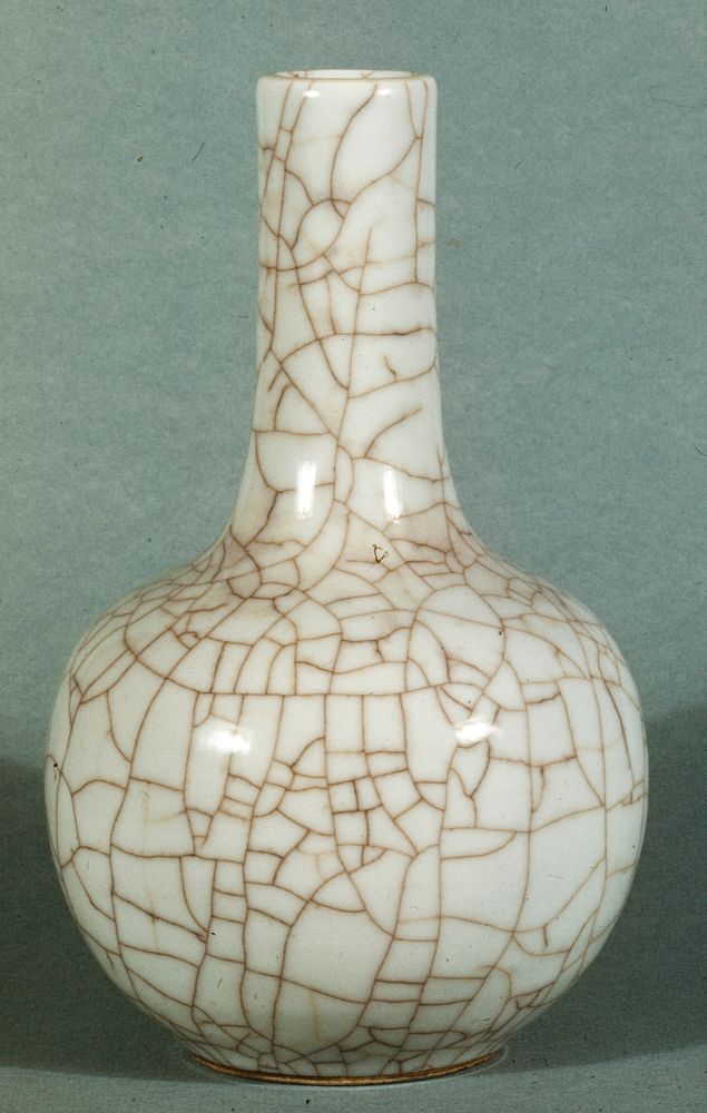 Bottle, round body, long cylindrical neck, white porcelain surface covered with giant crackle.. Original from the…