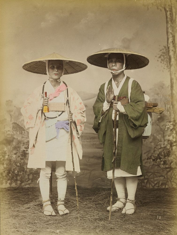 Man and woman wearing straw hats, short jackets (man's jacket is olive green; woman's jacket is white with pink squares)…