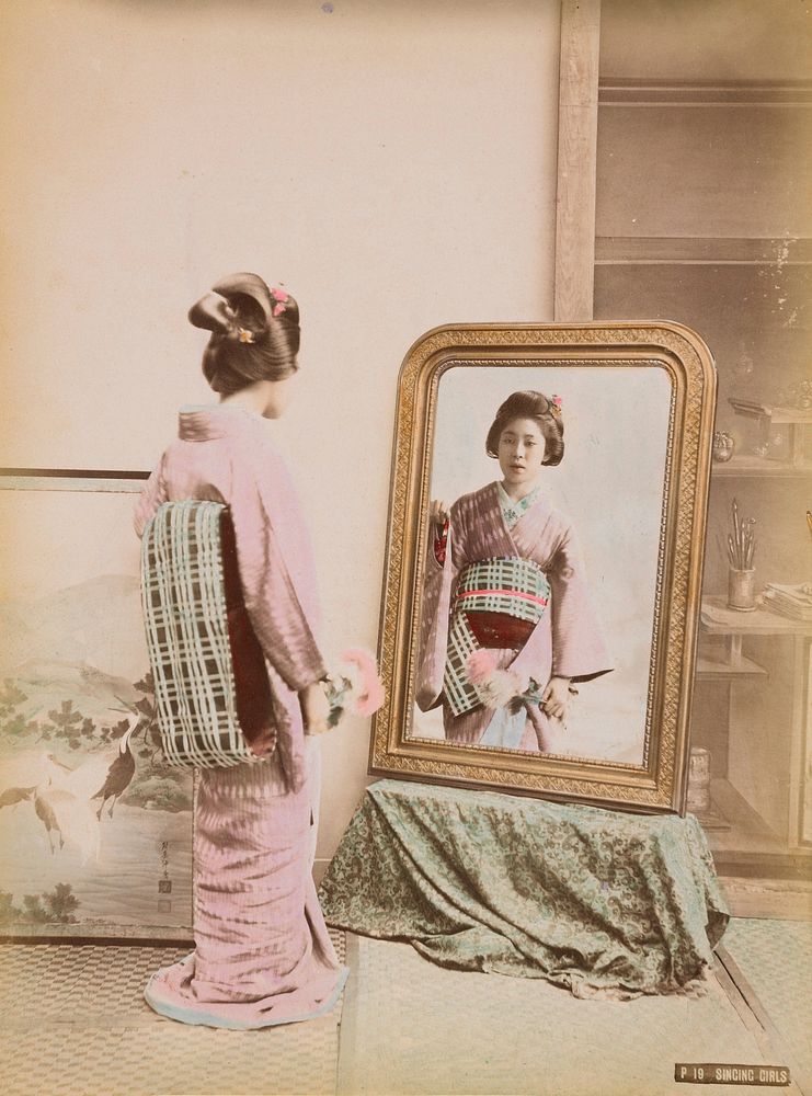 Standing young woman wearing a lavender kimono and pale blue and grey plaid obi, looking at her reflection in a mirror; girl…