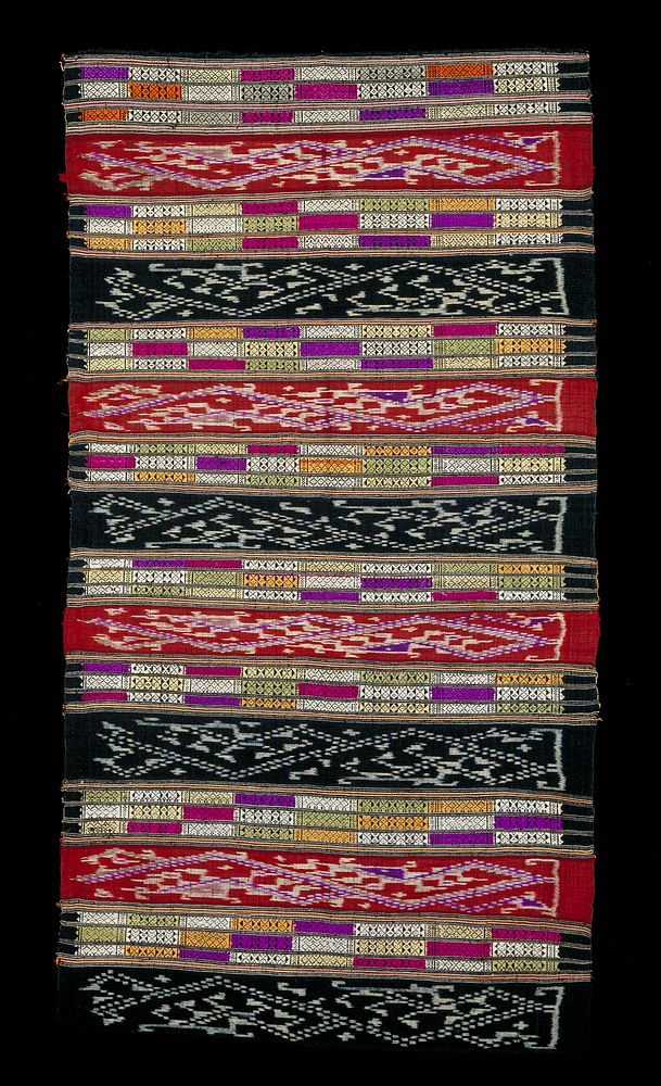 Alternating stripes of black and white ikat; white, green, dark pink, light yellow, purple and tan brocade and red, purple…