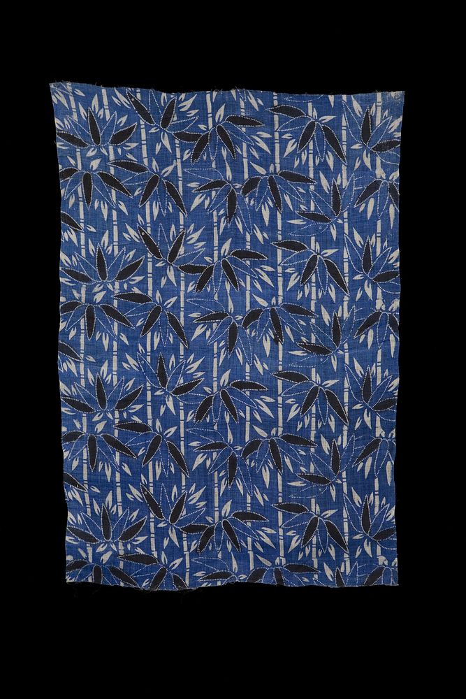 rectangular fragment of blue fabric with black and white bamboo designs; pattern consists of vertical white bamboo stalks…