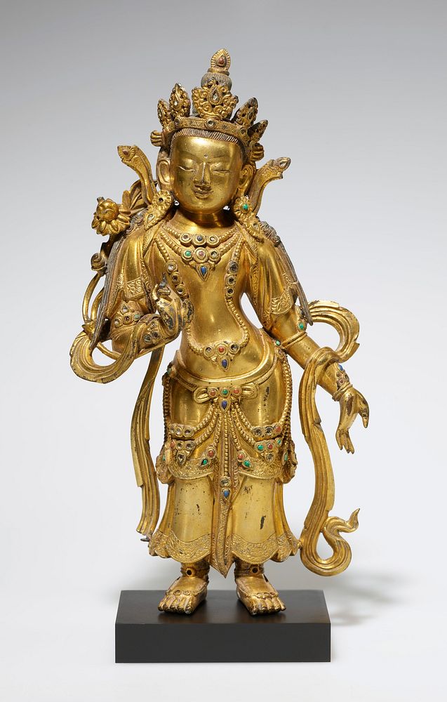standing gilt bronze figure in contraposto position, proper left hand open at side, right hand held in front, hanging…