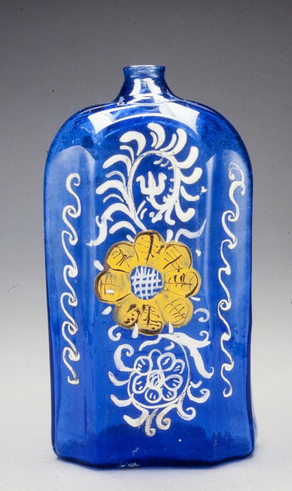 octagonal bottle, bright blue glass painted in enamel with one large yellow flower and white leaves, short applied neck and…