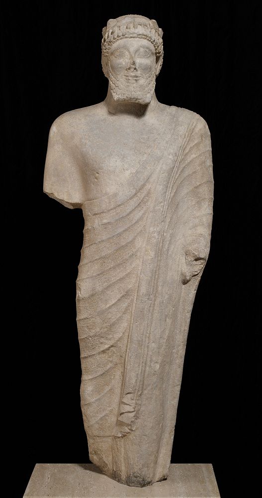 life-size carved statue of a bearded votary; In the archaic Cypriote style. The features show the mixed oriental style…