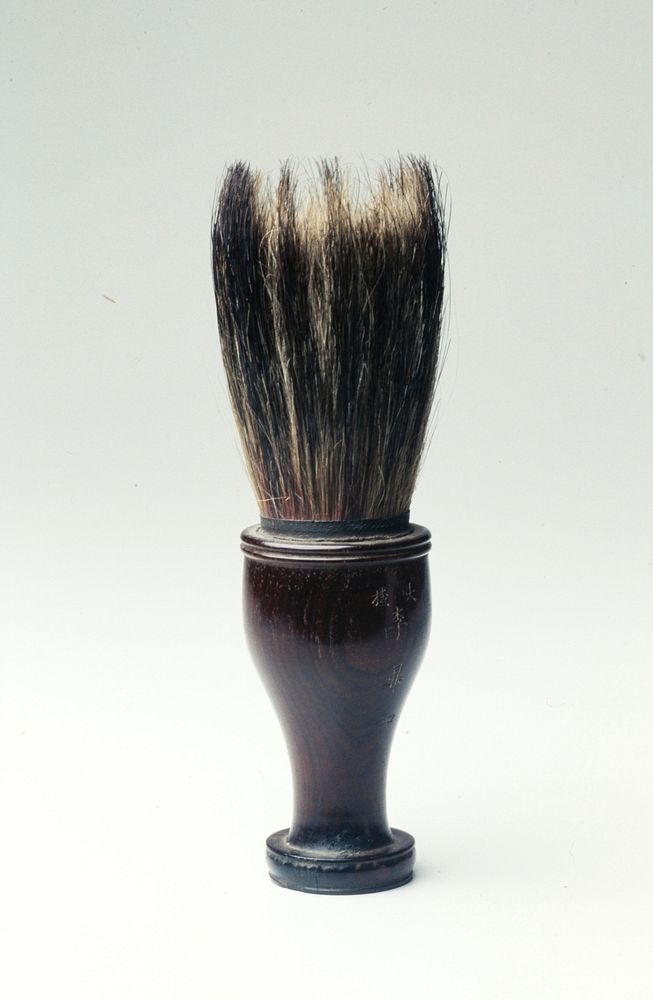 Large brush with flat-bottomed handle; bristles are varrying shades. Original from the Minneapolis Institute of Art.