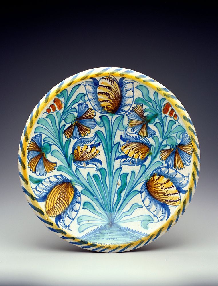 Title--tulip charger? Blue, yellow, green and brown floral design in basin with yellow and blue striping around rim;…
