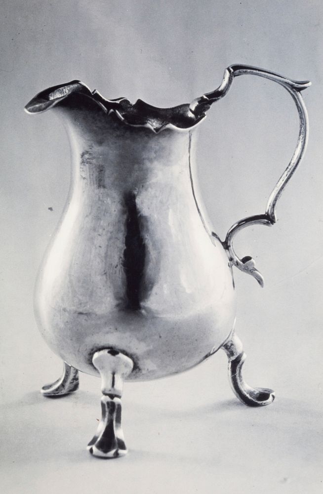 cream jug, pear-shaped, with shaped rim and folded lip; on three double-scrolled legs with flat, three-lobed feet; shaped…