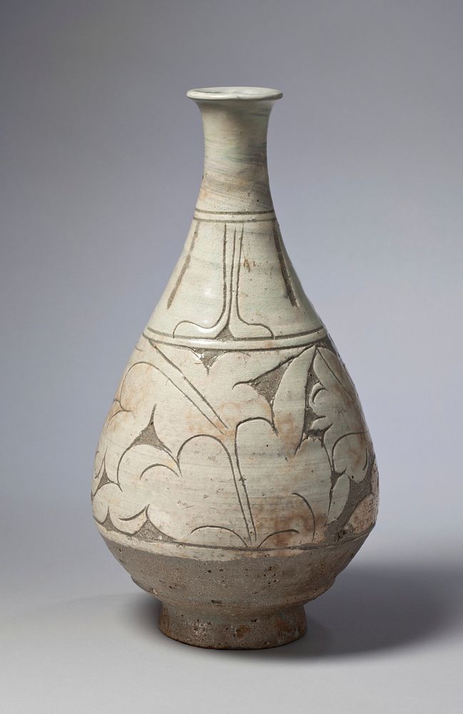 light green and tan bottle with grey recessed areas; pear-shaped; round foot; raised, billowing, floral leaf patterns.…
