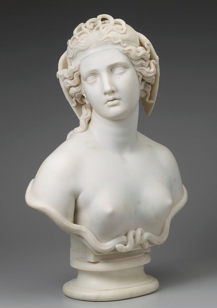 bust of a woman with a cluster of small snakes at the front of her head, wings at the side of her head; intertwined snakes…