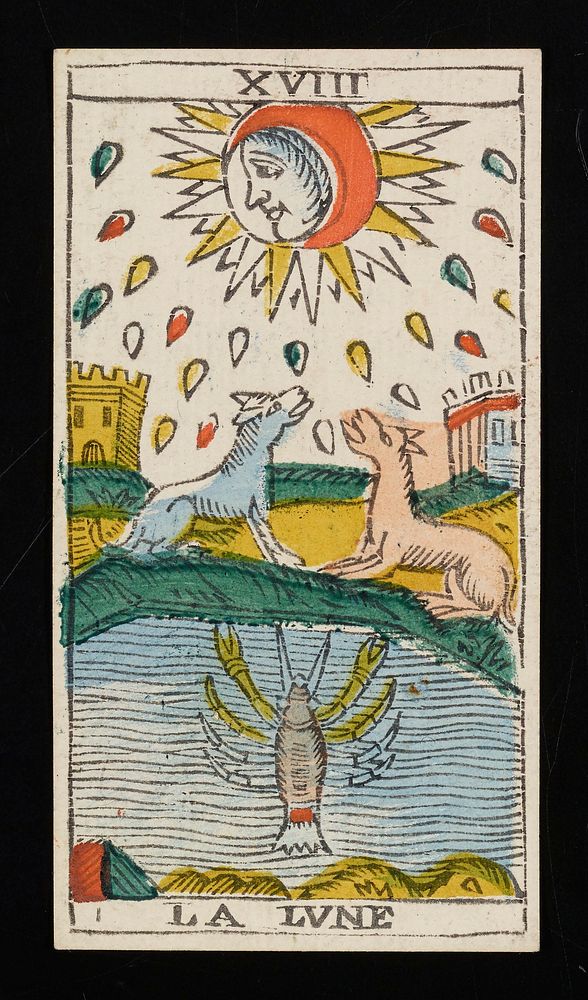 face in profile surrounded by crescent-shaped moon at top center of card; two towers and two dog-like creatures appear in…