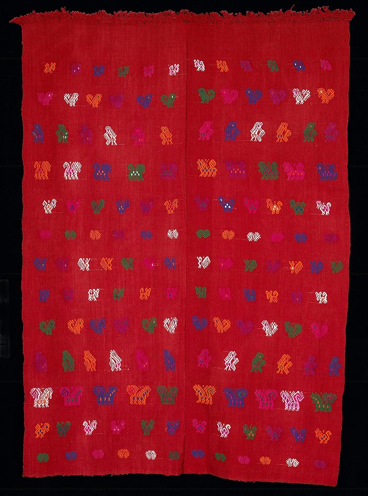 two paneled red cotton tzute; woven on a back strap loom with zoomorphic brocaded figures in white, yellow, green, blue and…