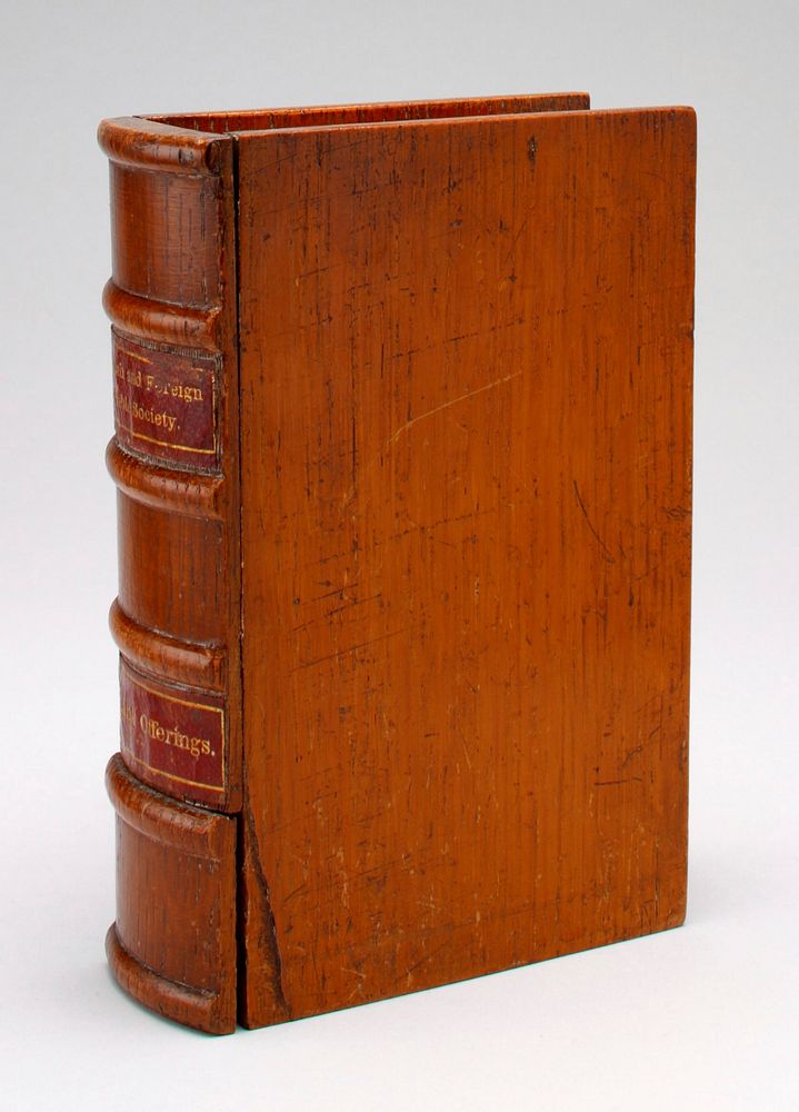 wooden book stained nut brown with labels on spine of red paper with gold lettering: "English and Foreign Bible Society" is…