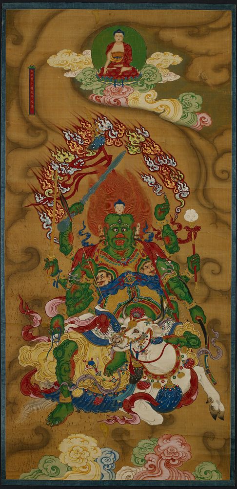 Seated Buddha at top center with pink, yellow and green clouds; green demon figure with eight arms seated on a white cow at…