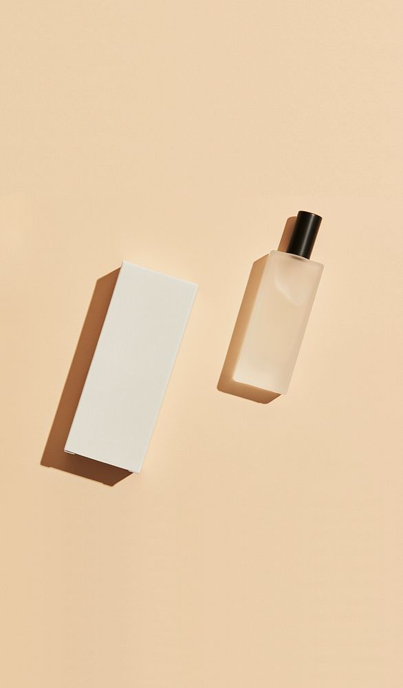 Perfume bottle flat lay, beige background