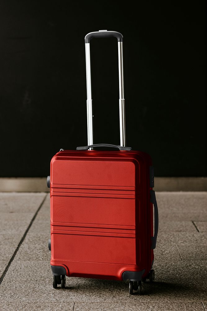 Red travel luggage on floor photo