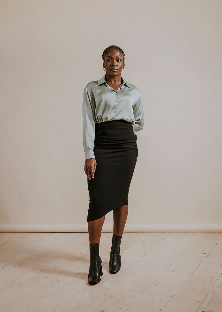 Businesswoman wearing silky shirt, black pencil skirt