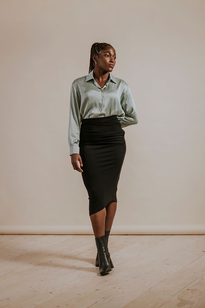 Businesswoman wearing silky shirt, black pencil skirt