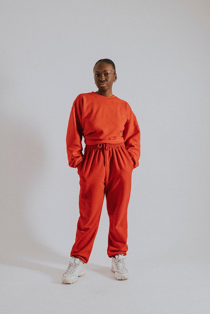 Woman in orange sweater, sweat pants, street fashion
