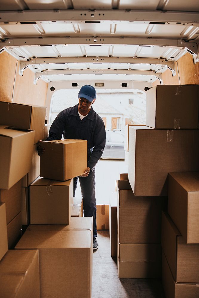 Moving worker unloading boxes from truck