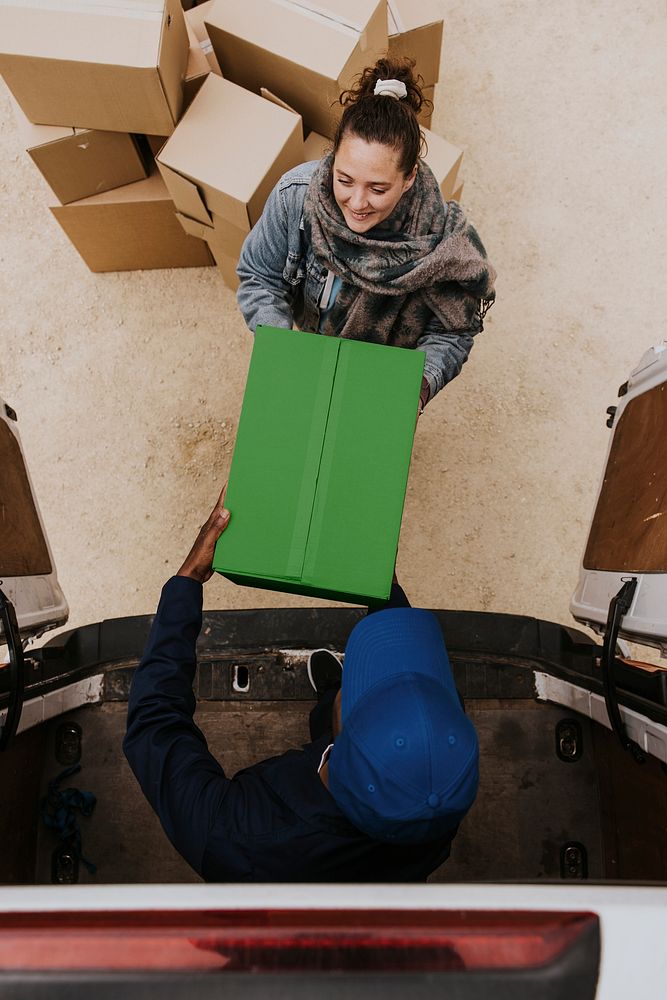 People loading boxes into truck, moving service