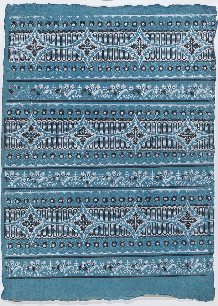 Sheet with four borders with a floral, dot, and stripe pattern