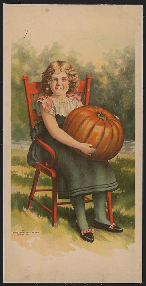 [Girl in red chair with pumpkin]