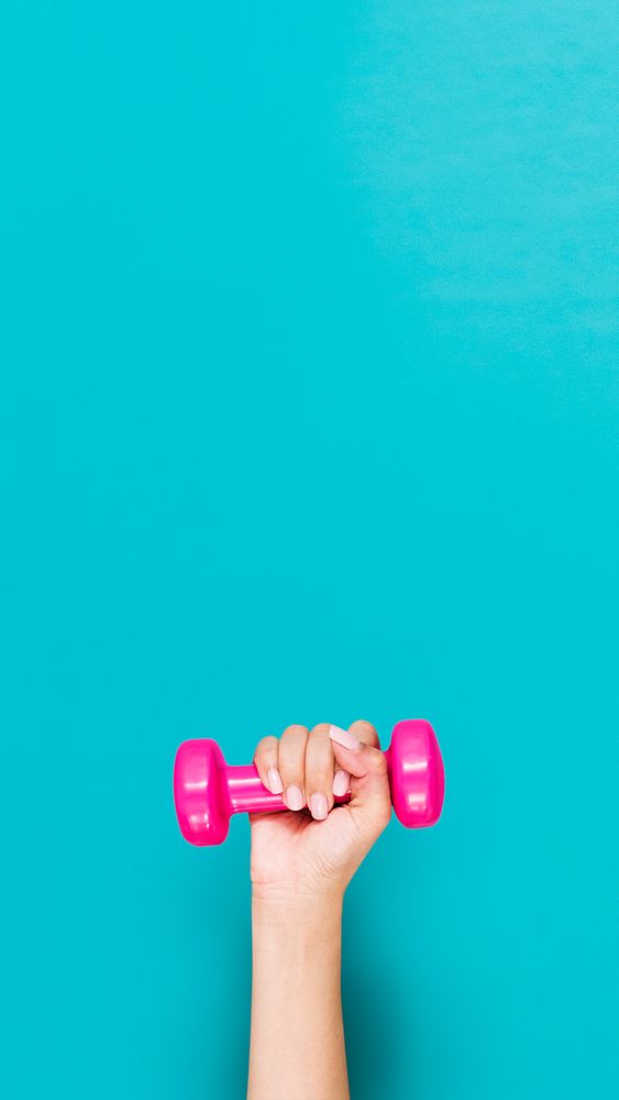 Woman's hand holding dumbbell, healthy lifestyle