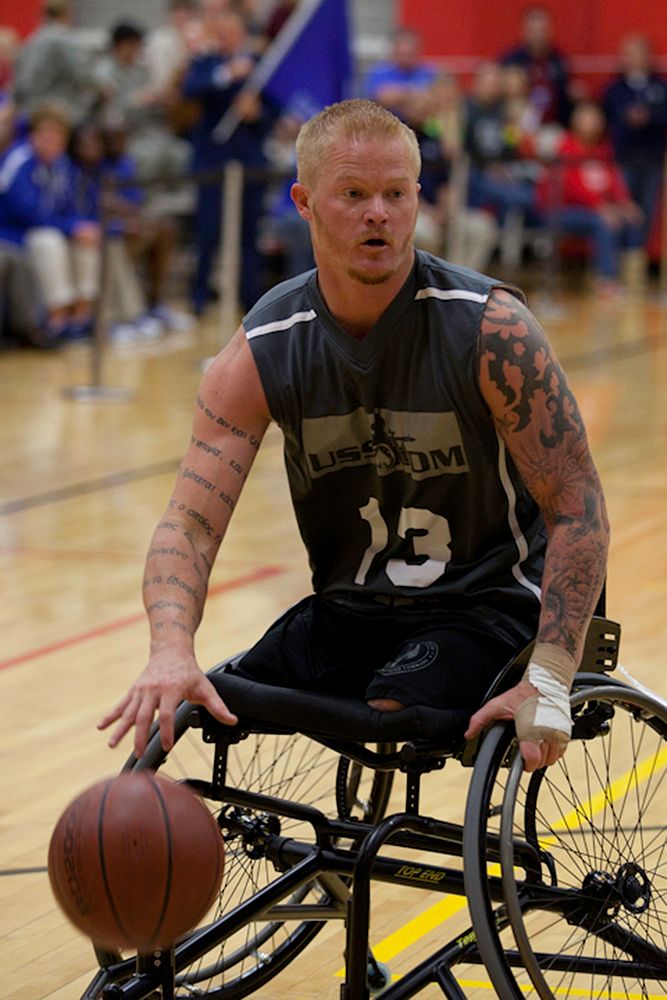 Retired U.S. Marine Corps Cpl. Justin Gaertner plays with the U.S. Special Operations Command wheelchair basketball team…