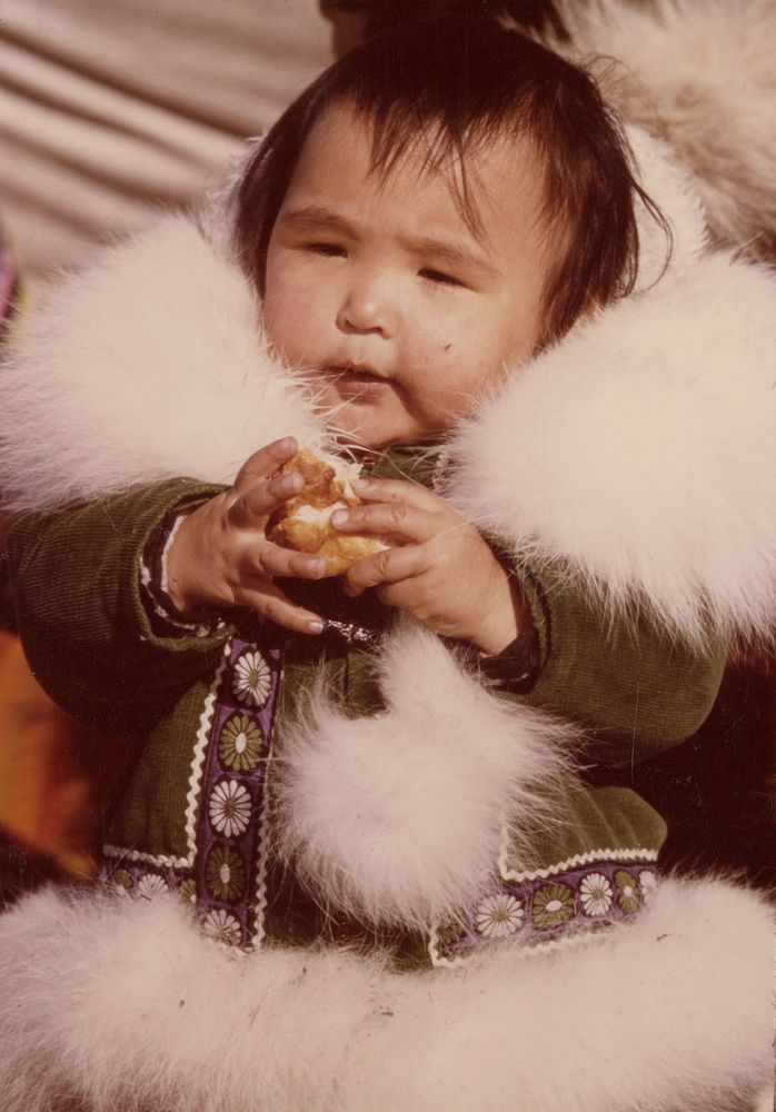 Eskimo youngster attending the Point Hope Whaling Festival and wearing a ruff of arctic fox fur. Original public domain…