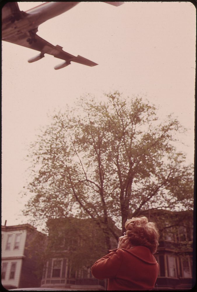 Mary Bruno Holds Her Ears Against Noise of Jet Coming in for a Landing on Runway 15r at Logan Airport. Original public…