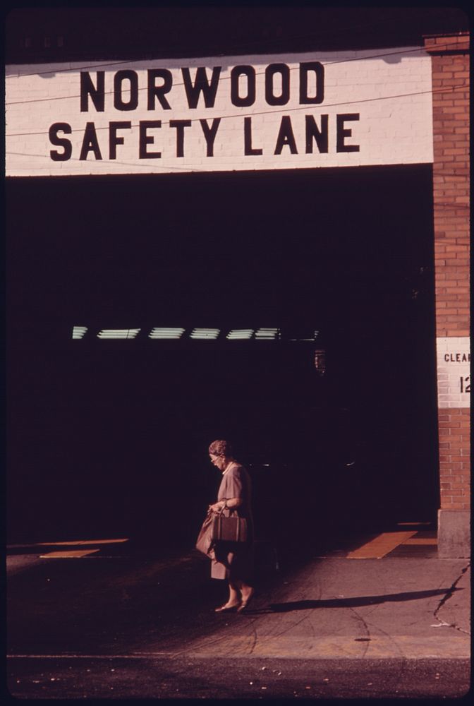 Resident of the Neighborhood in Norwood, Ohio, Walks in Front of the Safety Lane at the Auto Emission Inspection Station.