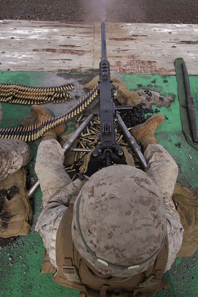 U.S. Marine Corps Cpl. Robert Dyke fires an M2 .50-caliber machine gun during the crew served weapons firing exercise on a…
