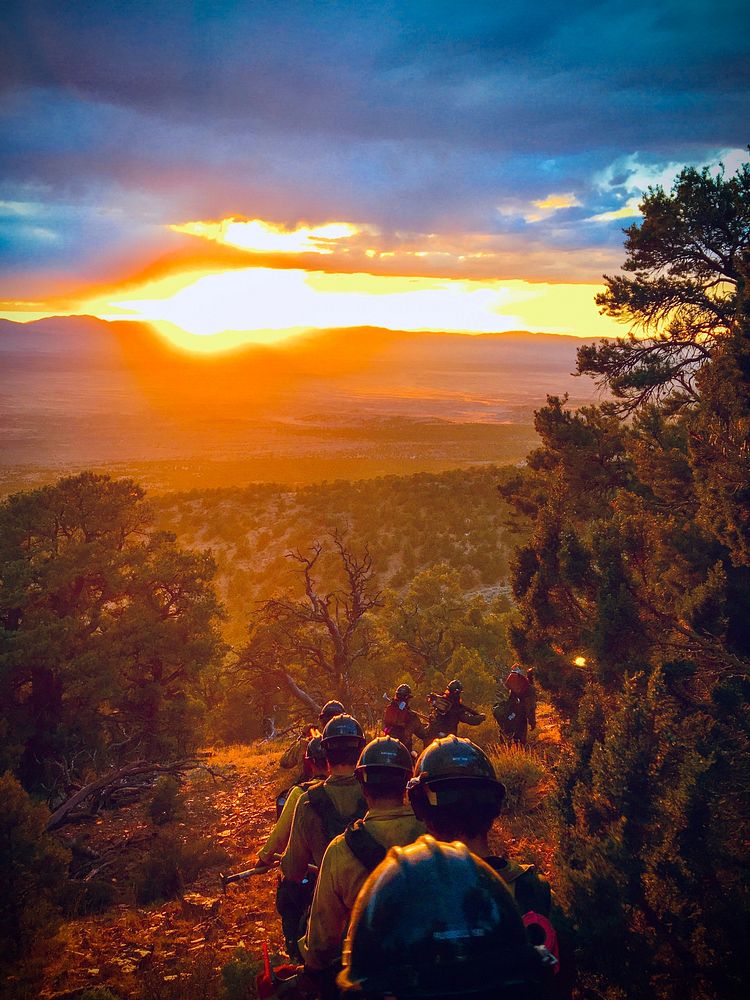 Rescue team hiking, sunset background. Original public domain image from Flickr