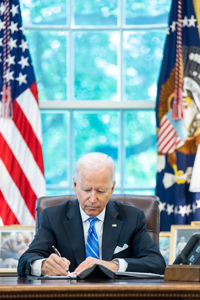 President Joe Biden works in the Oval Office of the White House, Wednesday, August 11, 2021. (Official White House Photo by…