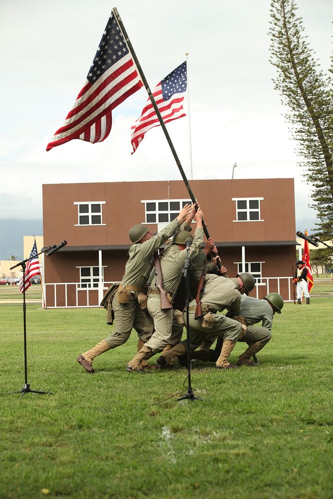 U.S. Marines assigned to Headquarters Battalion, Marine Corps Base (MCB) Hawaii, reenact the raising of the U.S. flag at Iwo…